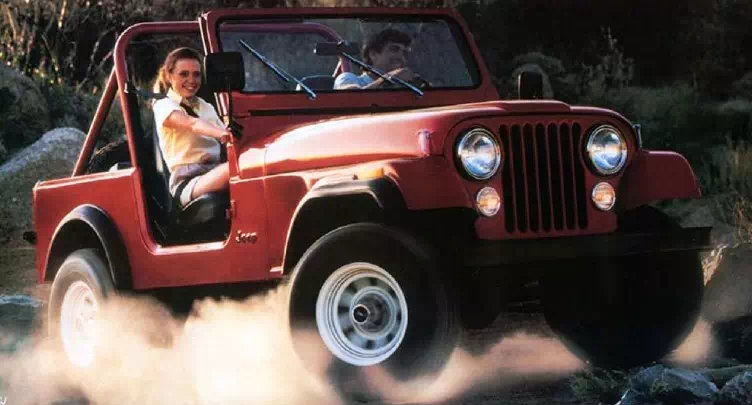 1985 Jeep Wrangler Vehicle Example A man and a woman driving a red painted jeep wrangler on a dirt road